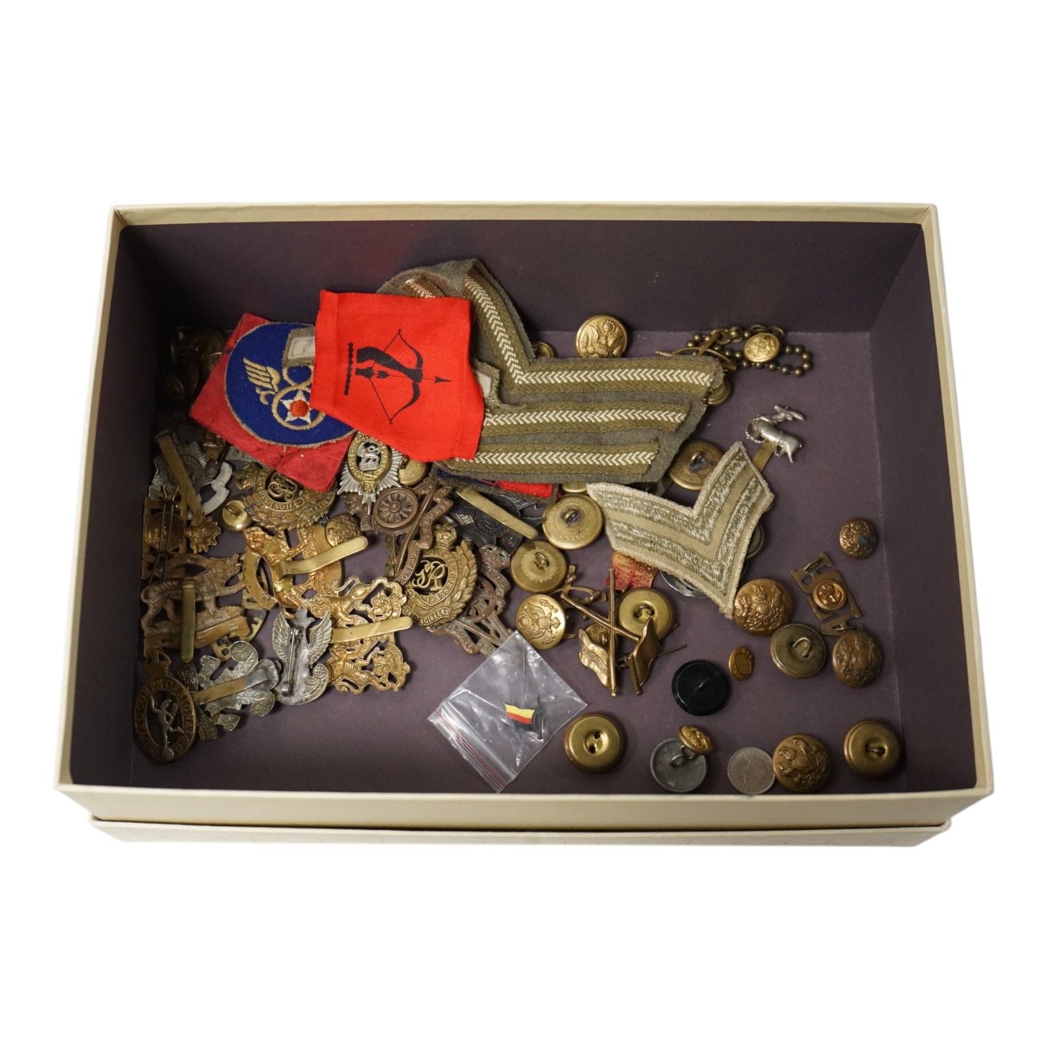 A collection of military medals and cap badges, etc. including